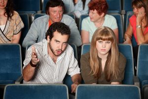 Friends at the cinema discuss the film.