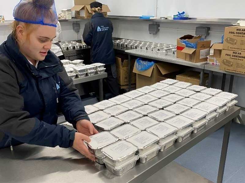 Leah Pull from The Auckland Project’s Catering Team, packing food at the charity’s Central Kitchen.